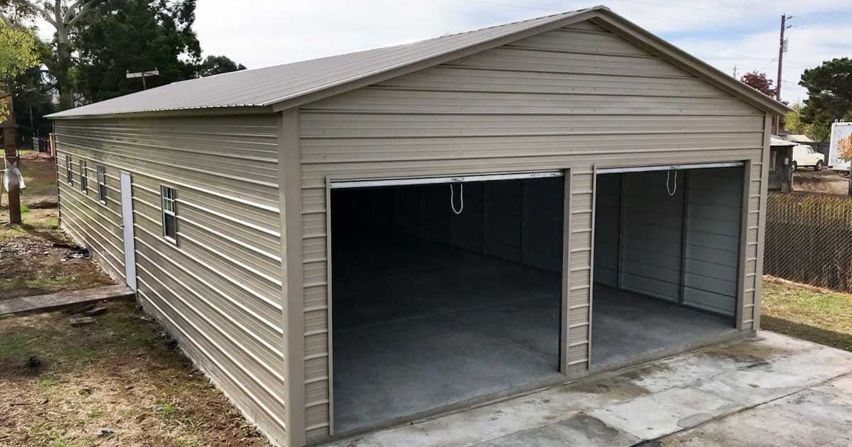 A large metal garage being installed by a crew, requiring proper permits
